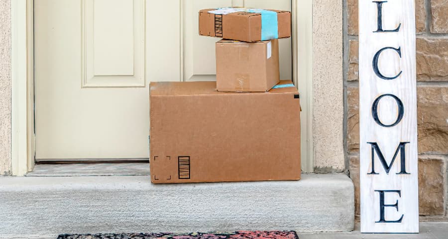 Deliveries on the front porch of a house with a welcome sign in St. George